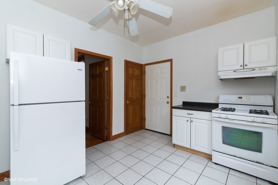 819 South Carpenter Street, Unit 3R Chicago, IL 60607 - Photo 6 of 10 a white refrigerator freezer and a stove top oven