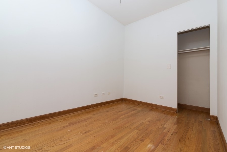 819 South Carpenter Street, Unit 3R Chicago, IL 60607 - Photo 8 of 10 a view of an empty room with wooden floor