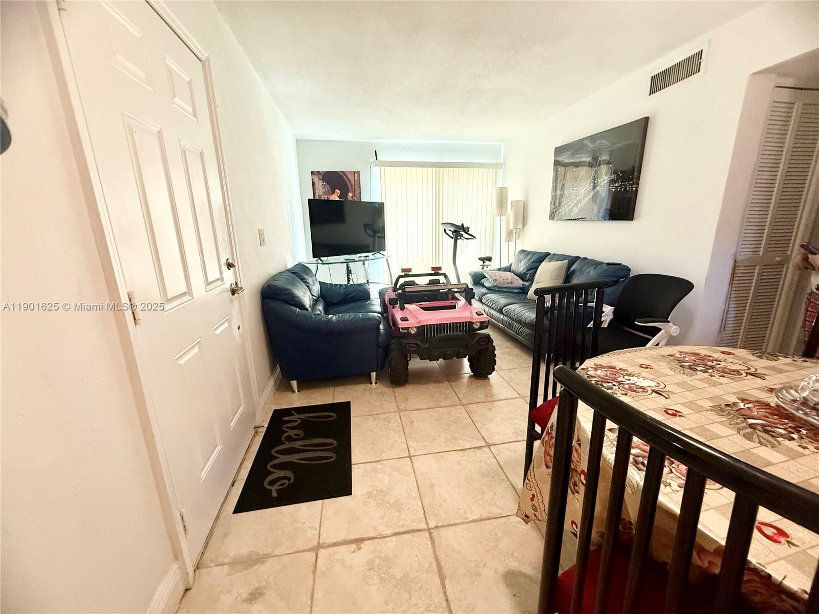 4201 Southwest 7th Street Miami, FL 33134 - Photo 14 of 23 a living room with furniture and a flat screen tv