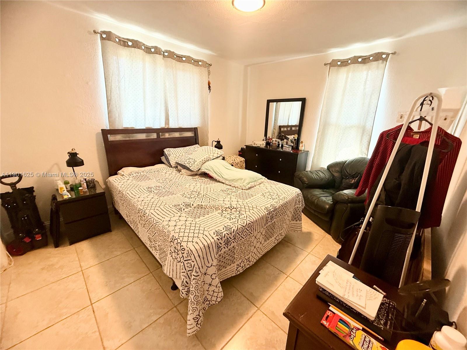 4201 Southwest 7th Street Miami, FL 33134 - Photo 15 of 23 a bedroom with a bed and wooden floor