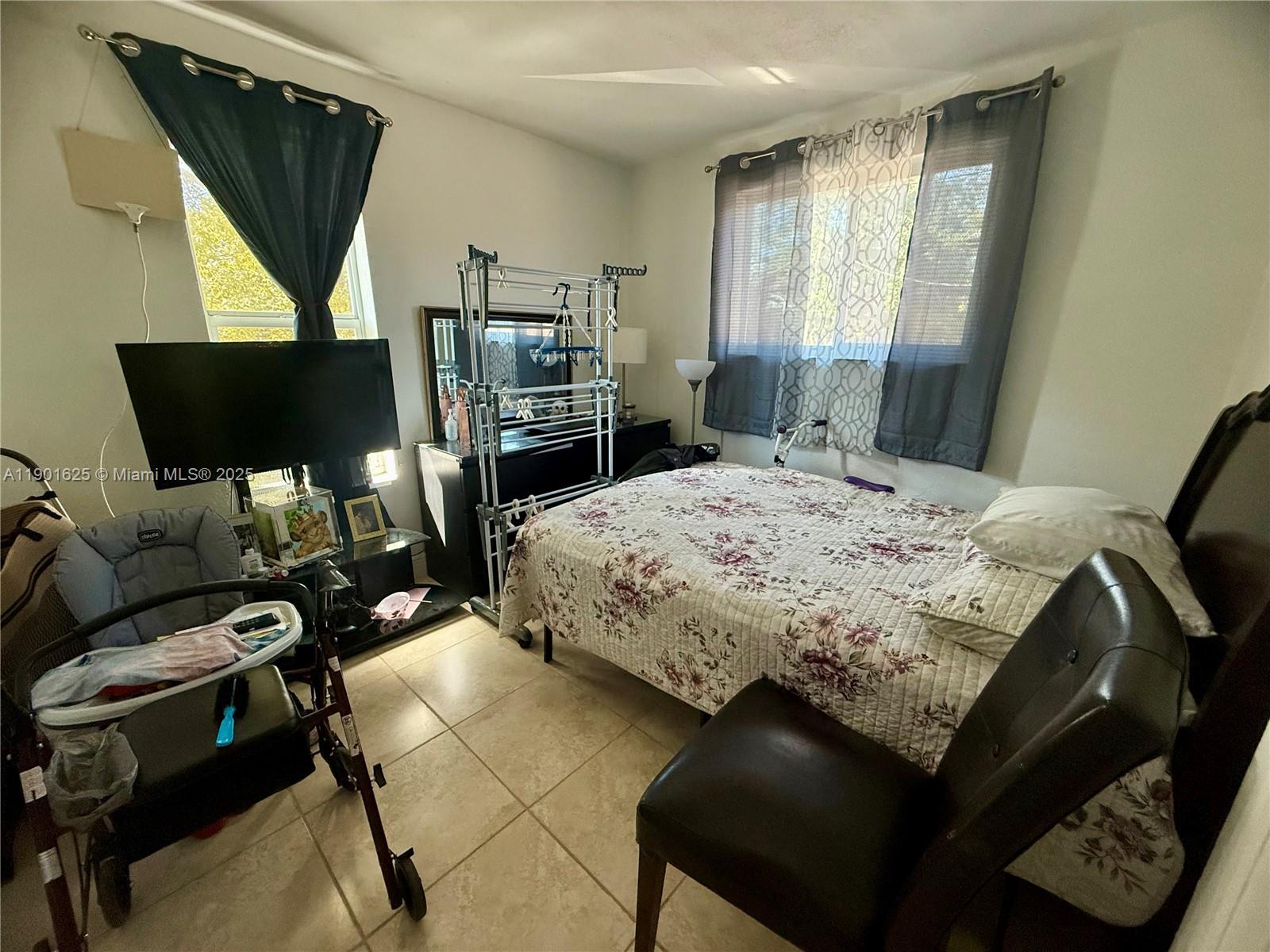 4201 Southwest 7th Street Miami, FL 33134 - Photo 16 of 23 a bedroom with a bed window and chair