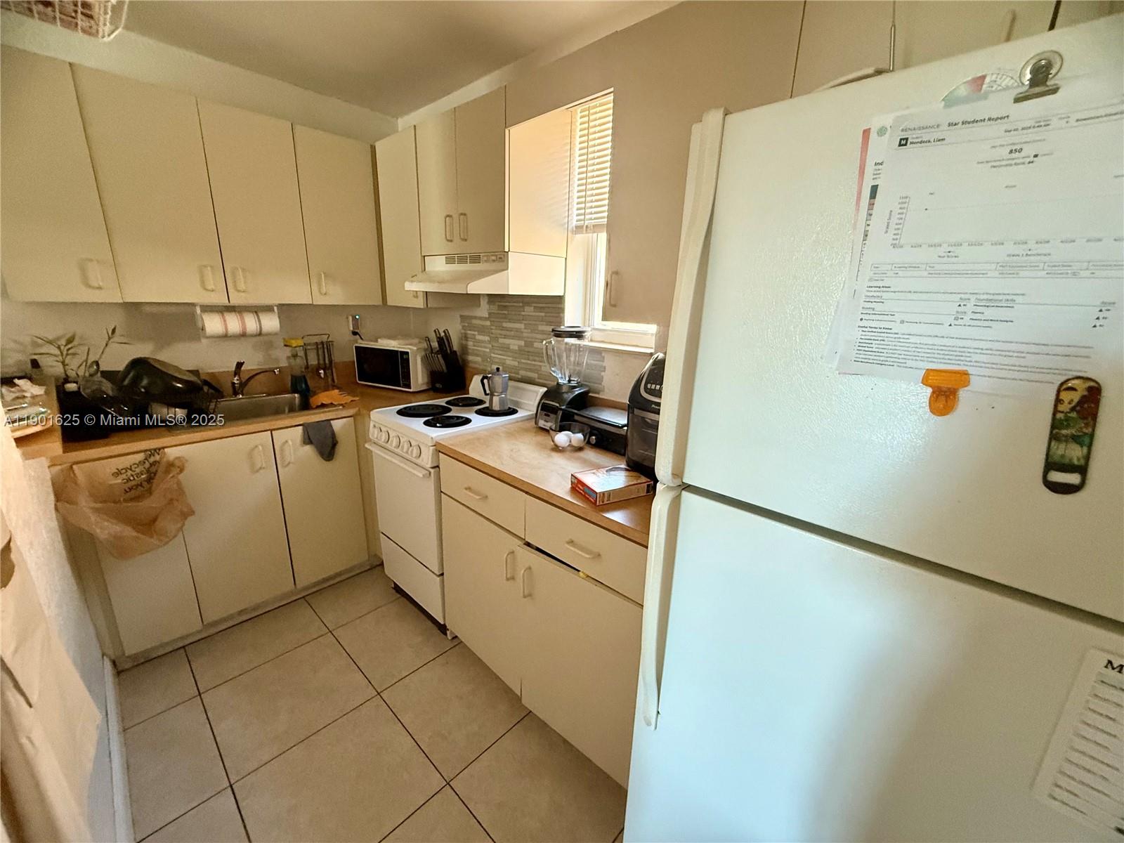 4201 Southwest 7th Street Miami, FL 33134 - Photo 20 of 23 a kitchen with stainless steel appliances a refrigerator sink and cabinets