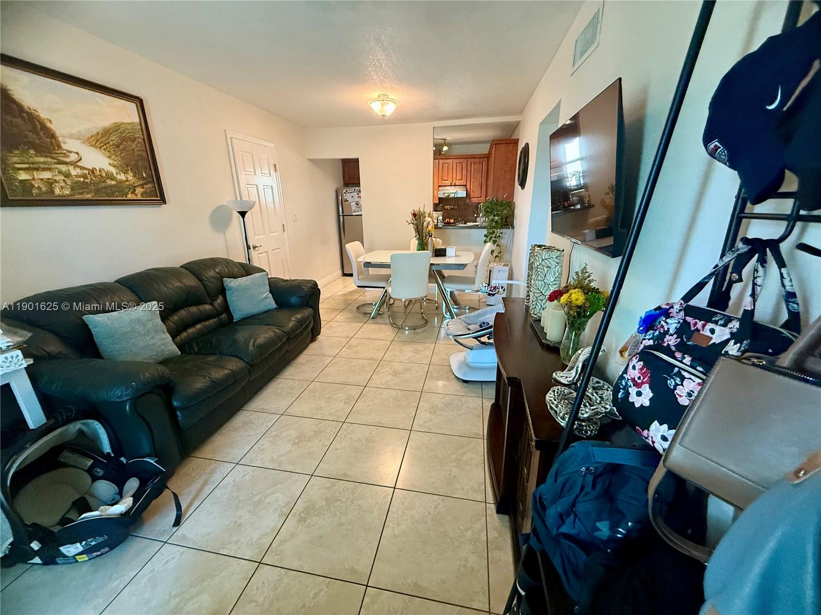 4201 Southwest 7th Street Miami, FL 33134 - Photo 2 of 23 a living room with furniture and a flat screen tv