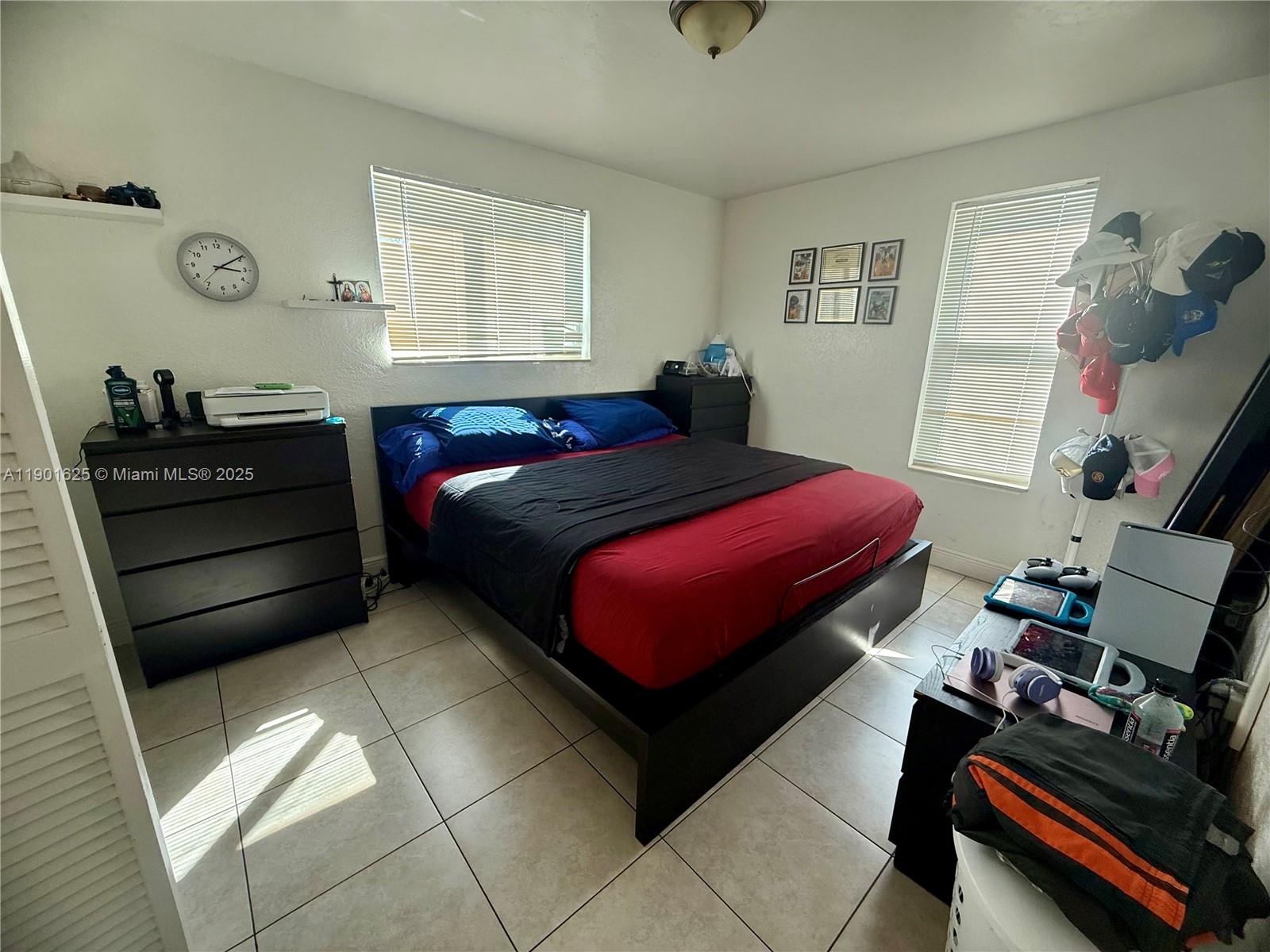 4201 Southwest 7th Street Miami, FL 33134 - Photo 21 of 23 a bedroom with a bed and wooden floor