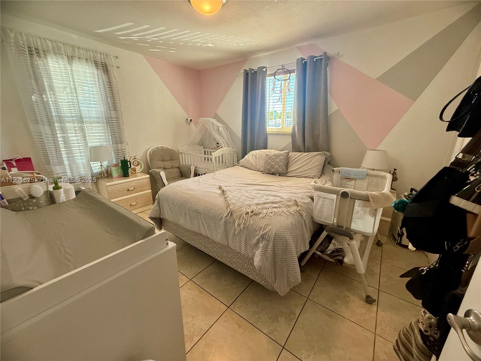 4201 Southwest 7th Street Miami, FL 33134 - Photo 3 of 23 a bedroom with a bed and large windows