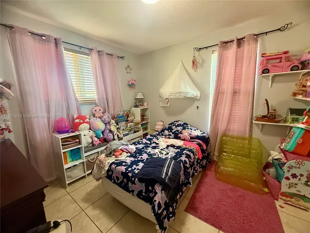 a bed room with a bed and a window