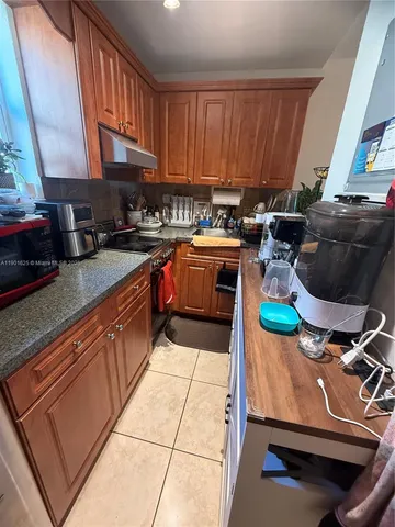 a kitchen with a sink a stove and a cabinets