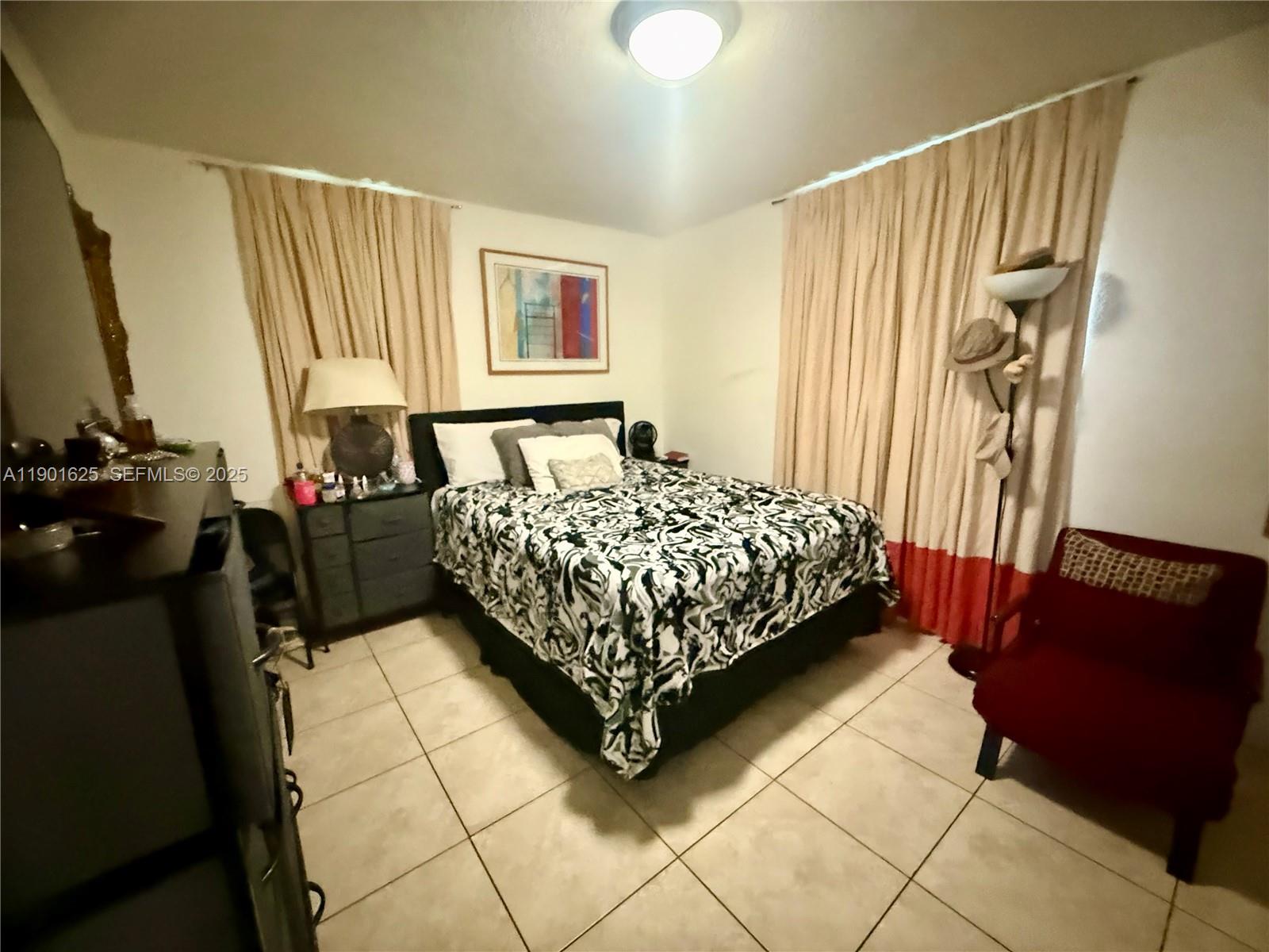 4201 Southwest 7th Street Miami, FL 33134 - Photo 9 of 23 a bed sitting in a bedroom next to a window