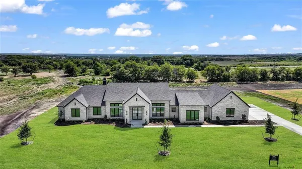 a aerial view of a house with a big yard