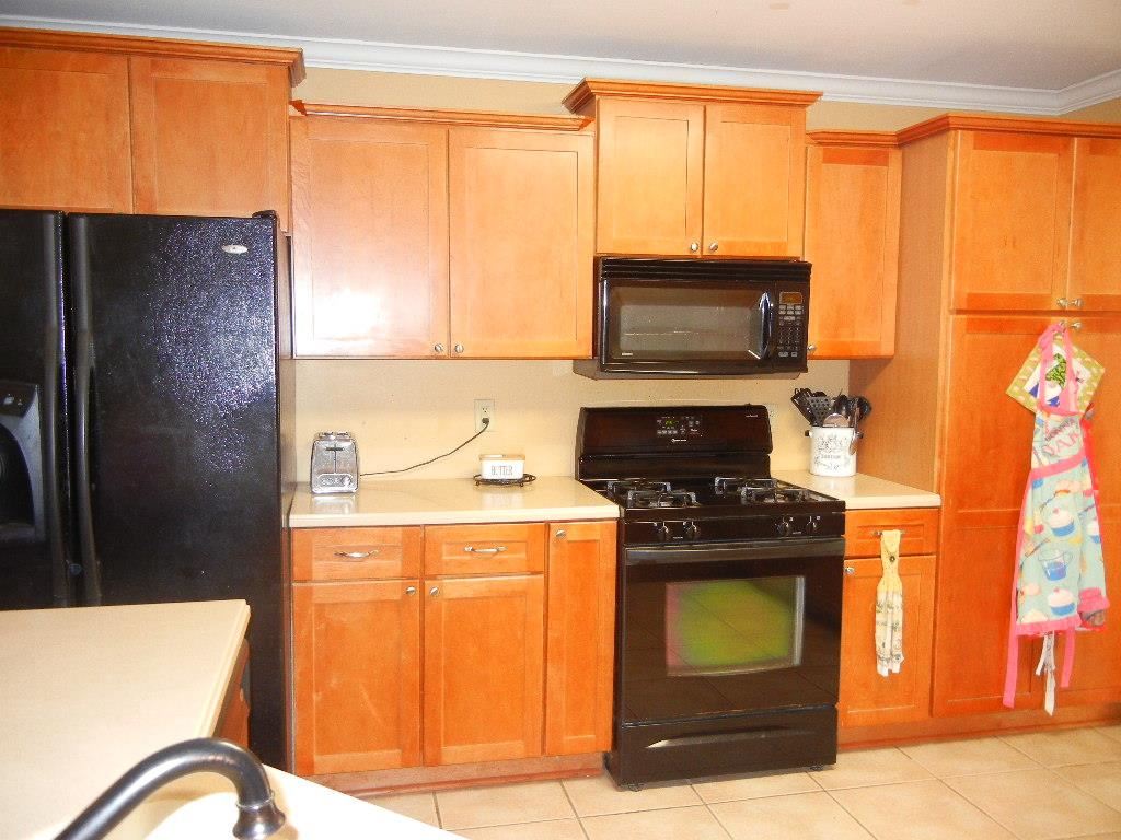 Maple cabinets, Corian countertops, large pantry, tlle floor.