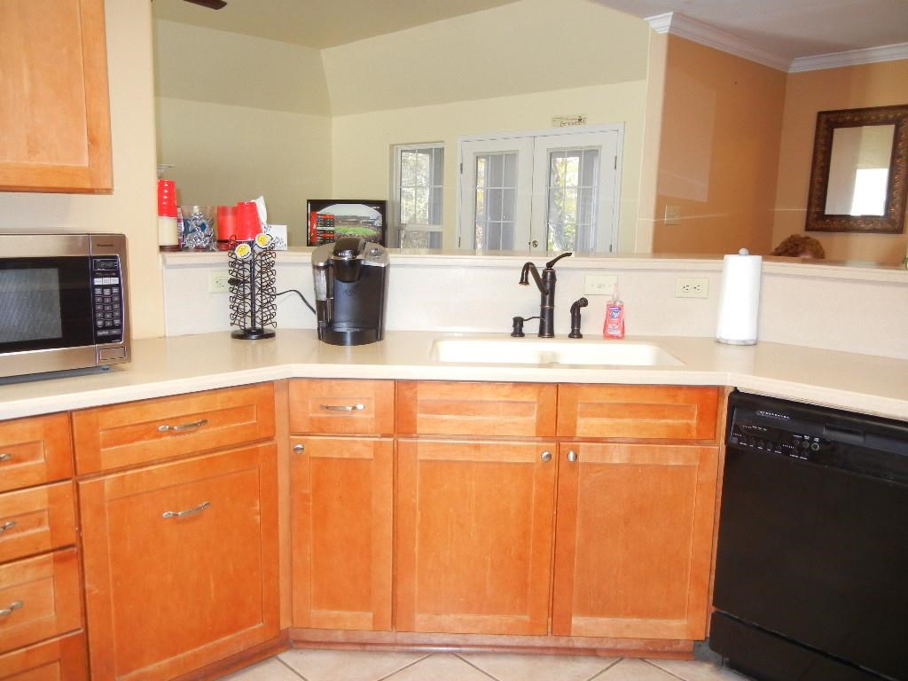 Tile floor, large breakfast bar, gas stove, lots of cabinets and large pantry