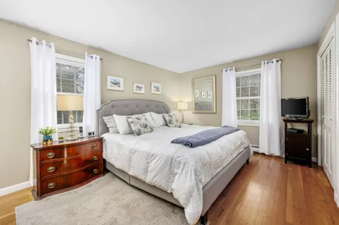 a bedroom with a bed and a tv