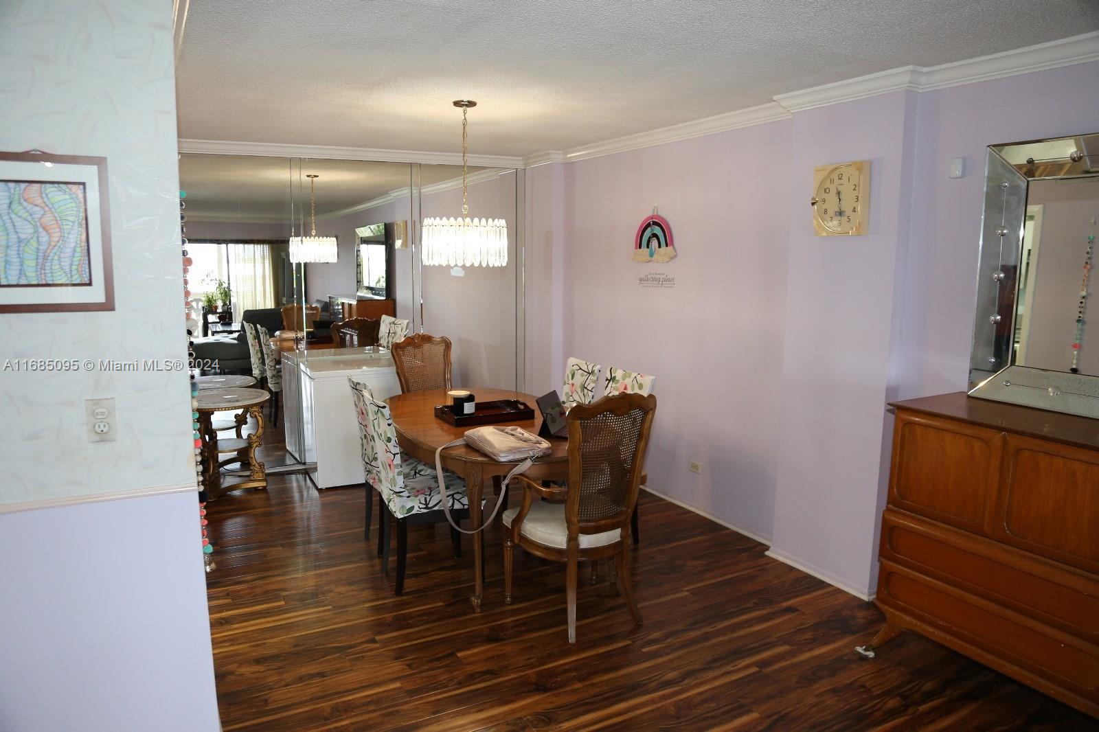 800 Northeast 195th Street, Unit 501 Miami, FL 33179 - Photo 11 of 39 a view of a dining room with furniture and wooden floor
