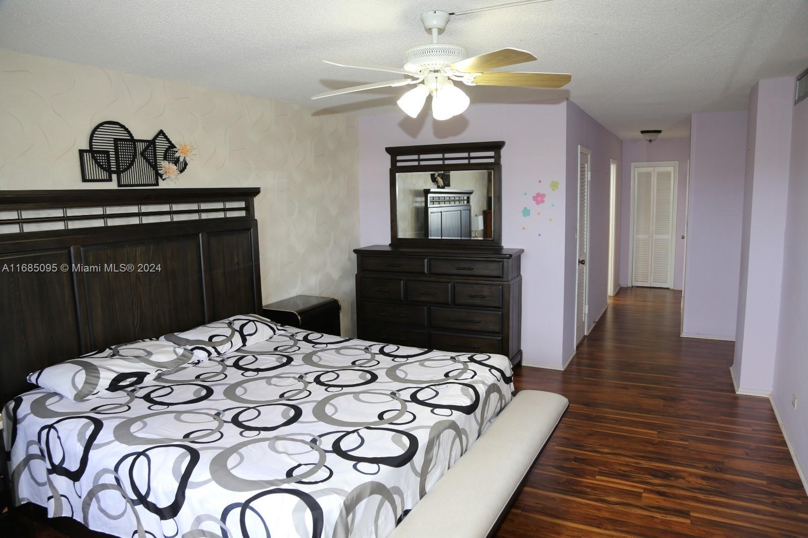 800 Northeast 195th Street, Unit 501 Miami, FL 33179 - Photo 14 of 39 a bedroom with a bed and a dresser