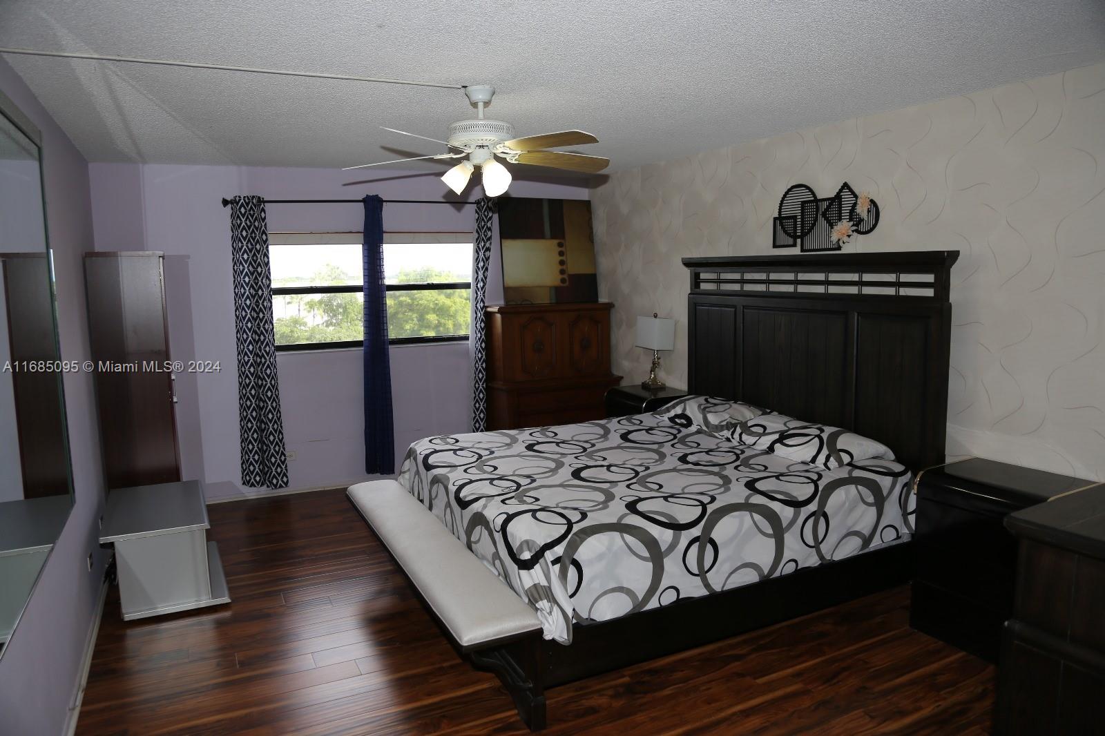 800 Northeast 195th Street, Unit 501 Miami, FL 33179 - Photo 15 of 39 a bedroom with a bed and a dresser