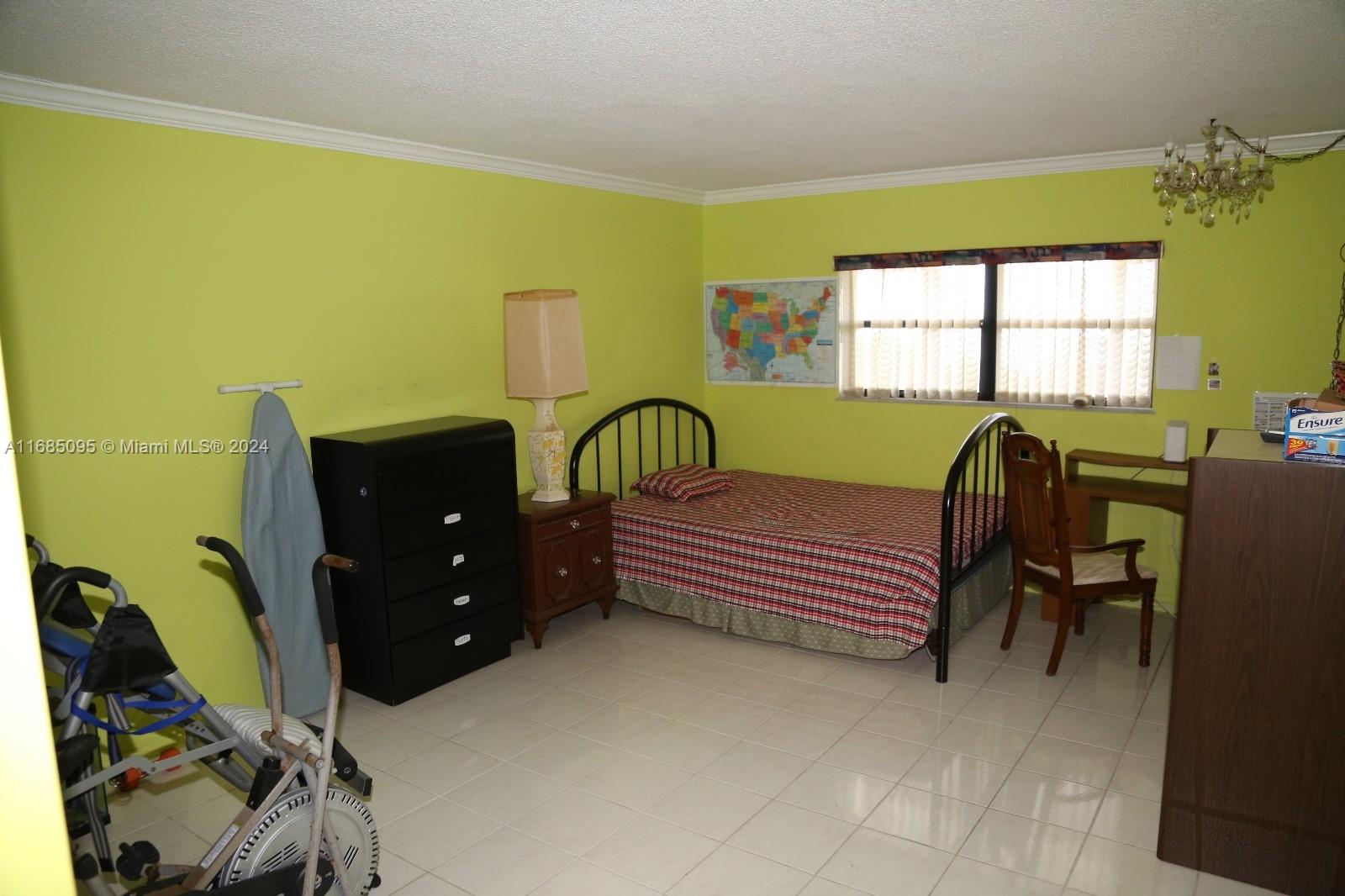 800 Northeast 195th Street, Unit 501 Miami, FL 33179 - Photo 18 of 39 a bedroom with a bed and a dresser