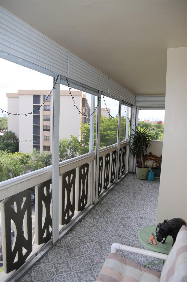 800 Northeast 195th Street, Unit 501 Miami, FL 33179 - Photo 27 of 39 a view of a porch with furniture