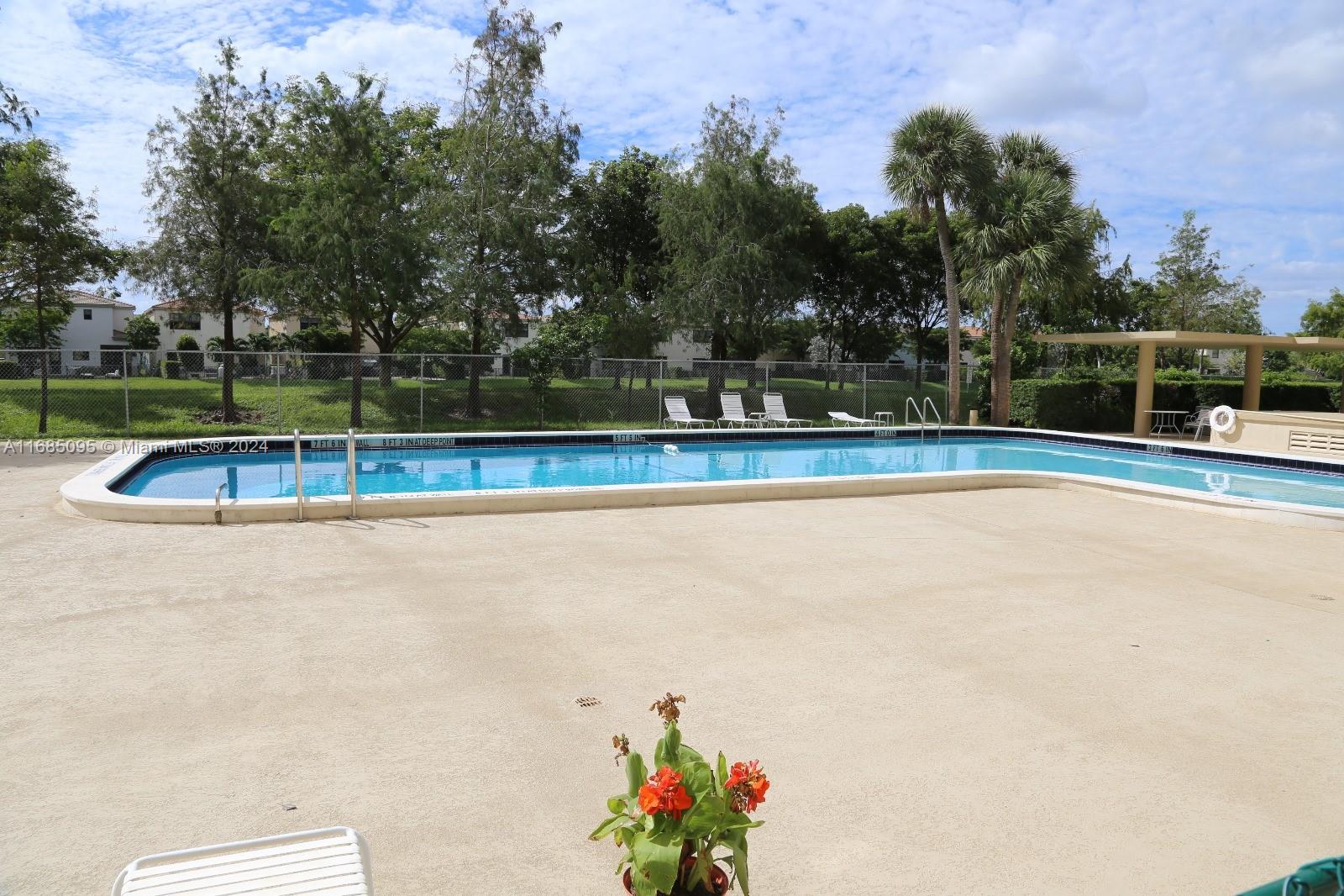 800 Northeast 195th Street, Unit 501 Miami, FL 33179 - Photo 35 of 39 a view of a swimming pool with an outdoor seating