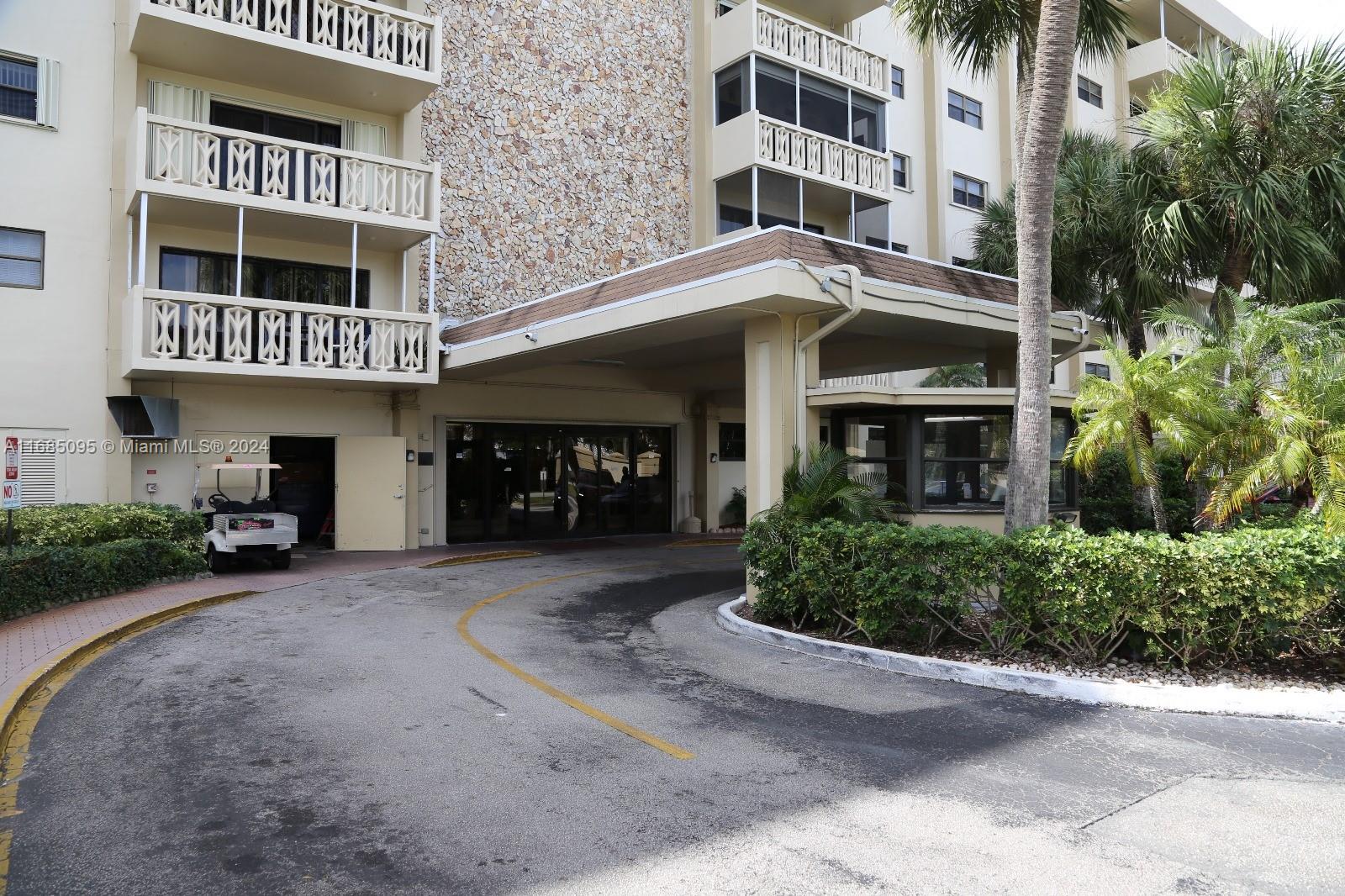 800 Northeast 195th Street, Unit 501 Miami, FL 33179 - Photo 37 of 39 a view of a building with a yard and balcony