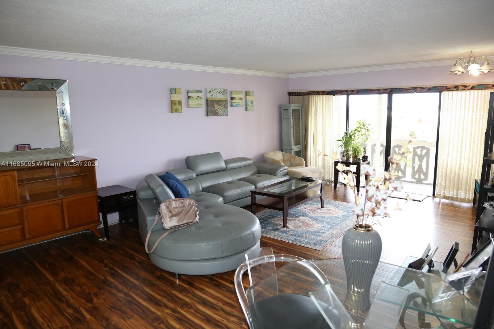 800 Northeast 195th Street, Unit 501 Miami, FL 33179 - Photo 7 of 39 a living room with furniture and a large window