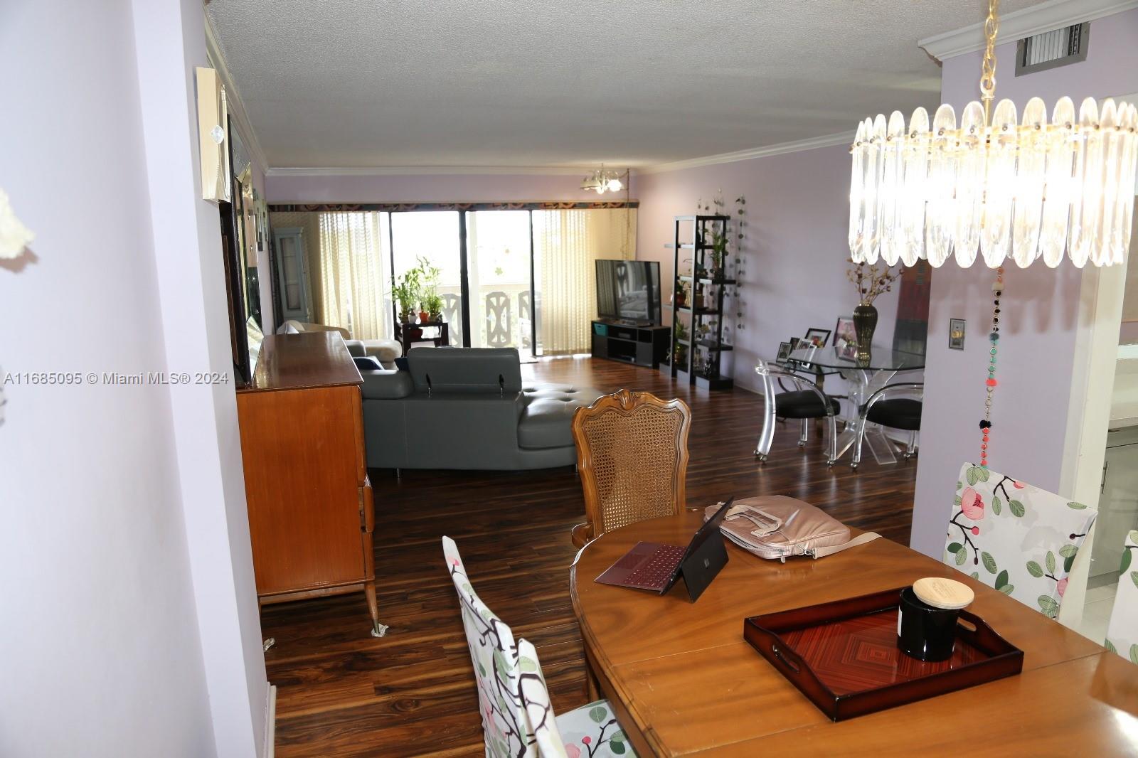800 Northeast 195th Street, Unit 501 Miami, FL 33179 - Photo 9 of 39 a living room with furniture and a large window