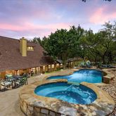 a view of a house with swimming pool and sitting area