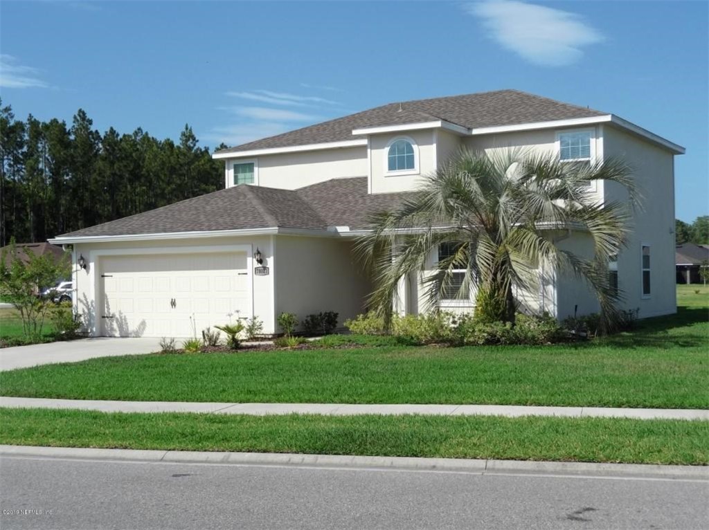 78021 Saddle Rock Road Yulee, FL 32097 - Photo 1 of 1 a front view of a house with a yard and garage