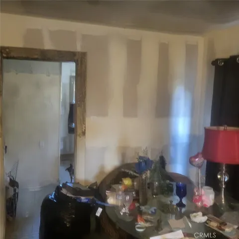 a bedroom with a bed and a chandelier fan