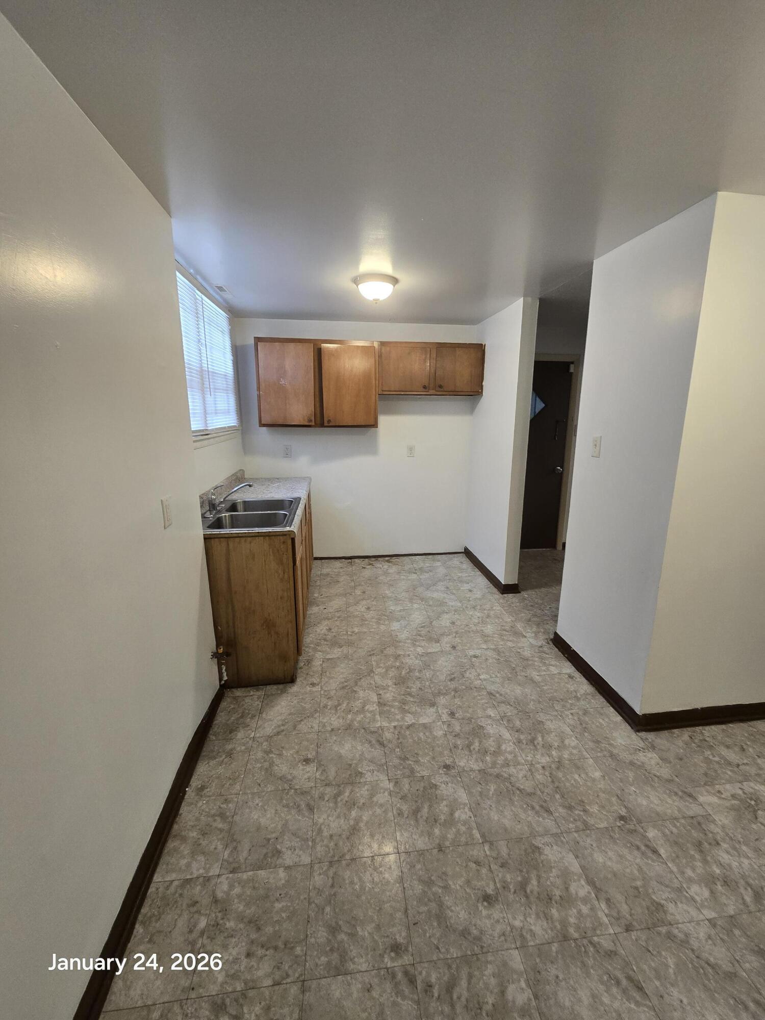 1676 West 13th Avenue Gary, IN 46404 - Photo 9 of 12 a view of a storage & utility room with fridge and wooden floor