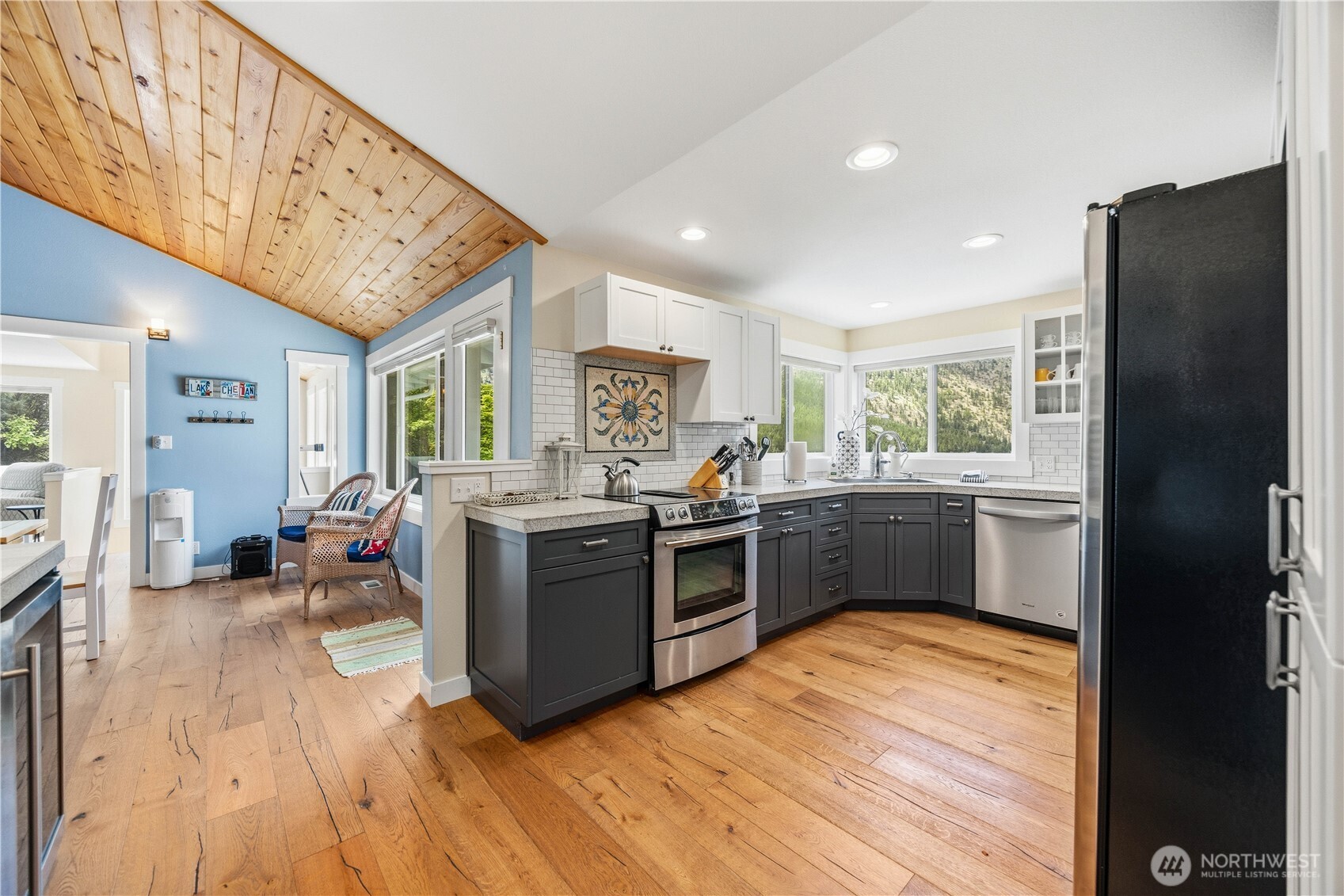 141 Sunset Place Manson, WA 98831 - Photo 11 of 38 a kitchen with stainless steel appliances granite countertop a refrigerator a sink dishwasher a stove and white countertops with wooden floor