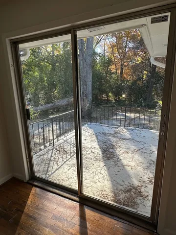 a view of a room with wooden floor and porch