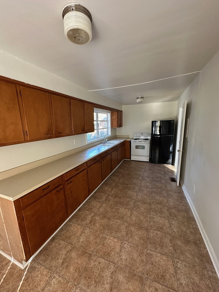 4250 Adams Street Columbus, GA 31907 - Photo 7 of 12 a kitchen with stainless steel appliances granite countertop a refrigerator and a sink