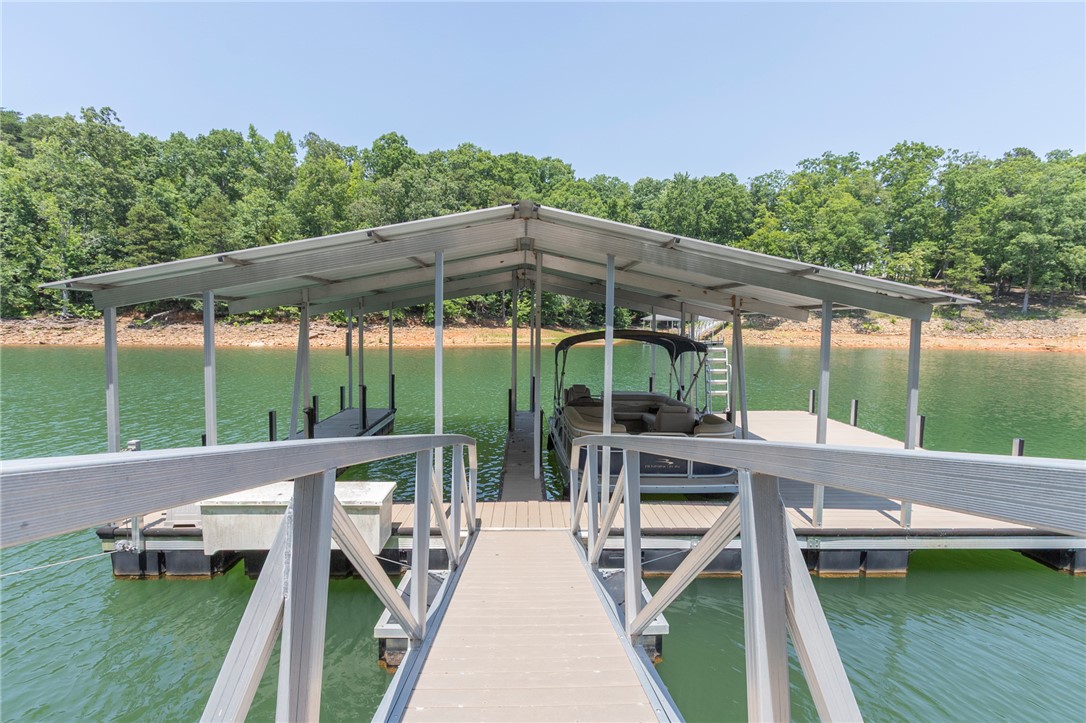 202 Plantation Point Anderson, SC 29625 - Photo 3 of 48 Boathouse with a walkway leading to the calm lake, ready for aquatic adventures.