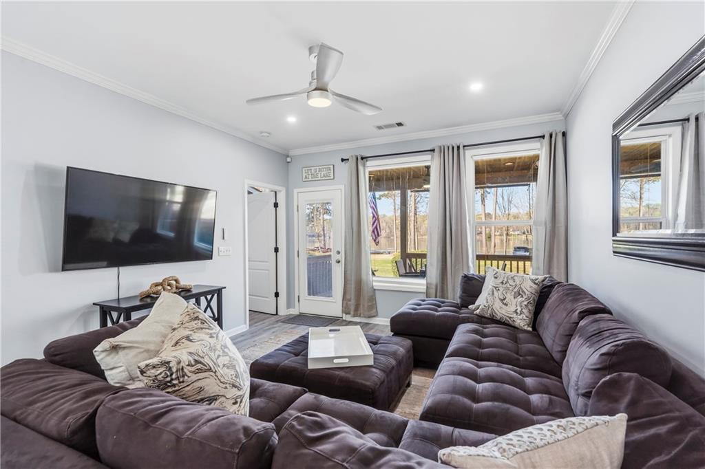 549 Old Phoenix Road Northeast, Unit 104 Eatonton, GA 31024 - Photo 11 of 49 a living room with furniture and a flat screen tv