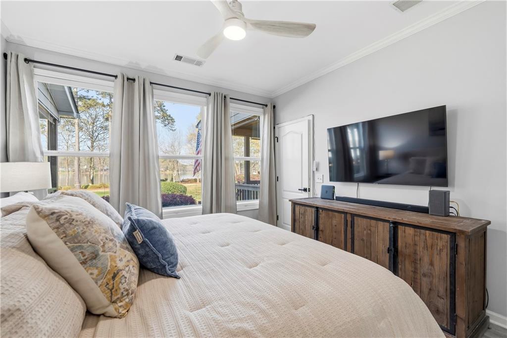 549 Old Phoenix Road Northeast, Unit 104 Eatonton, GA 31024 - Photo 14 of 49 a bedroom with a flat screen television and a bed