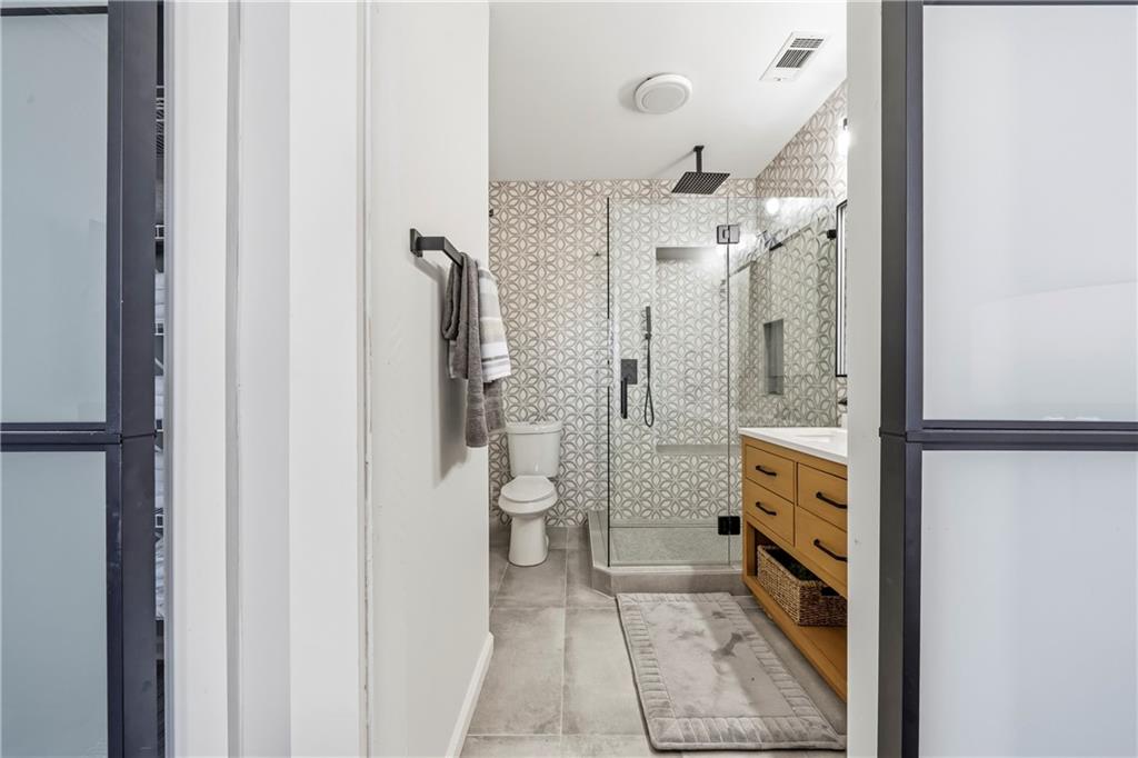 549 Old Phoenix Road Northeast, Unit 104 Eatonton, GA 31024 - Photo 16 of 49 a bathroom with a glass shower door