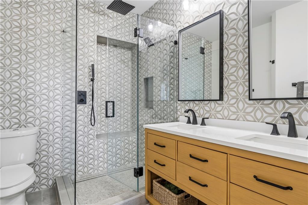 549 Old Phoenix Road Northeast, Unit 104 Eatonton, GA 31024 - Photo 17 of 49 a bathroom with a sink a toilet and shower