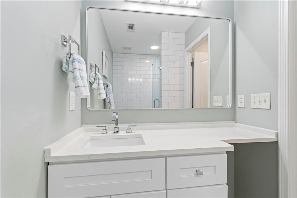 549 Old Phoenix Road Northeast, Unit 104 Eatonton, GA 31024 - Photo 31 of 49 a bathroom with a sink vanity and a mirror
