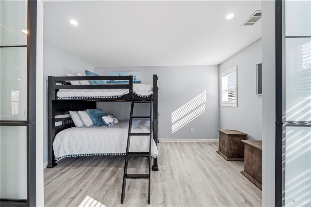 549 Old Phoenix Road Northeast, Unit 104 Eatonton, GA 31024 - Photo 34 of 49 a bedroom with a bed and wooden floor