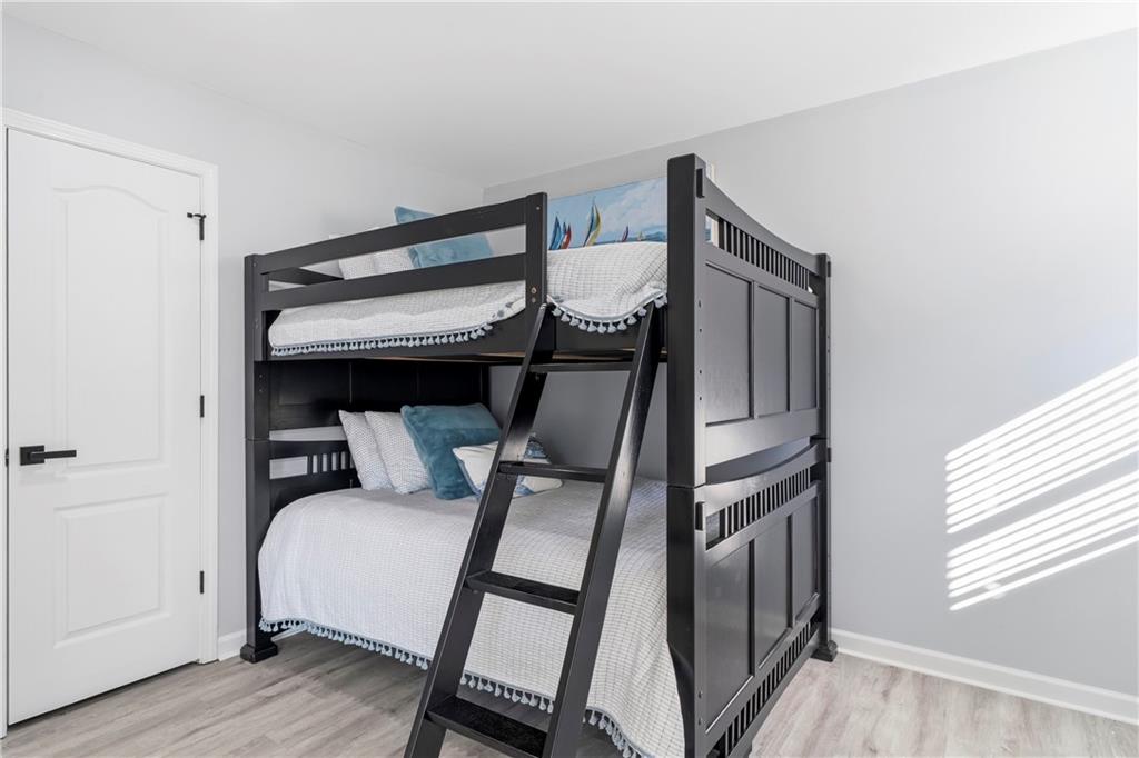 549 Old Phoenix Road Northeast, Unit 104 Eatonton, GA 31024 - Photo 35 of 49 a bedroom with a bed and a window