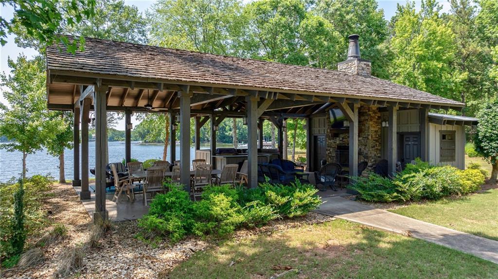 549 Old Phoenix Road Northeast, Unit 104 Eatonton, GA 31024 - Photo 39 of 49 a view of a patio with table and chairs under an umbrella
