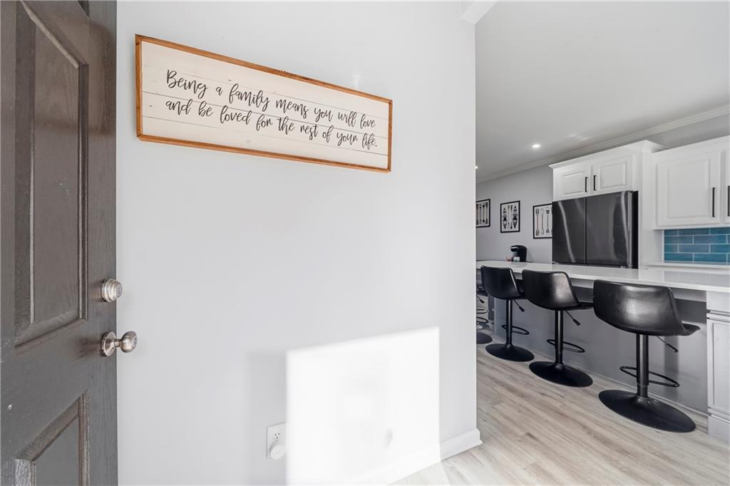 549 Old Phoenix Road Northeast, Unit 104 Eatonton, GA 31024 - Photo 4 of 49 a view of a kitchen with a refrigerator and a table