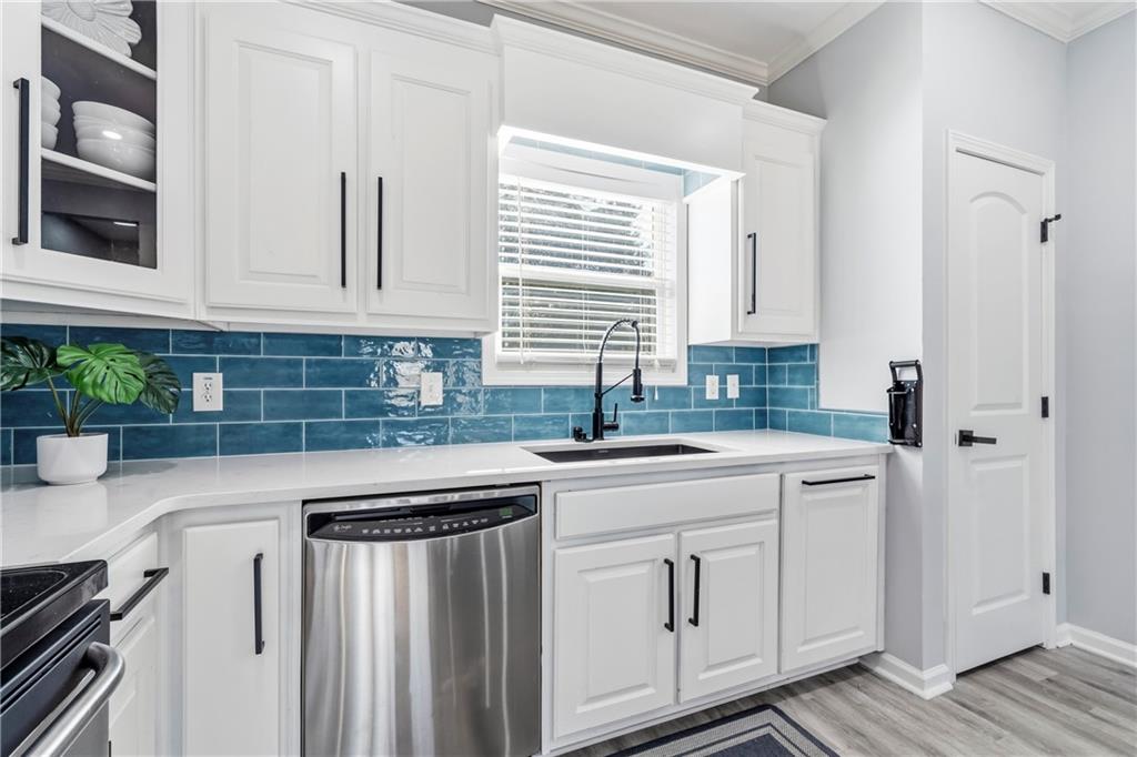 549 Old Phoenix Road Northeast, Unit 104 Eatonton, GA 31024 - Photo 6 of 49 a kitchen with white cabinets and white appliances