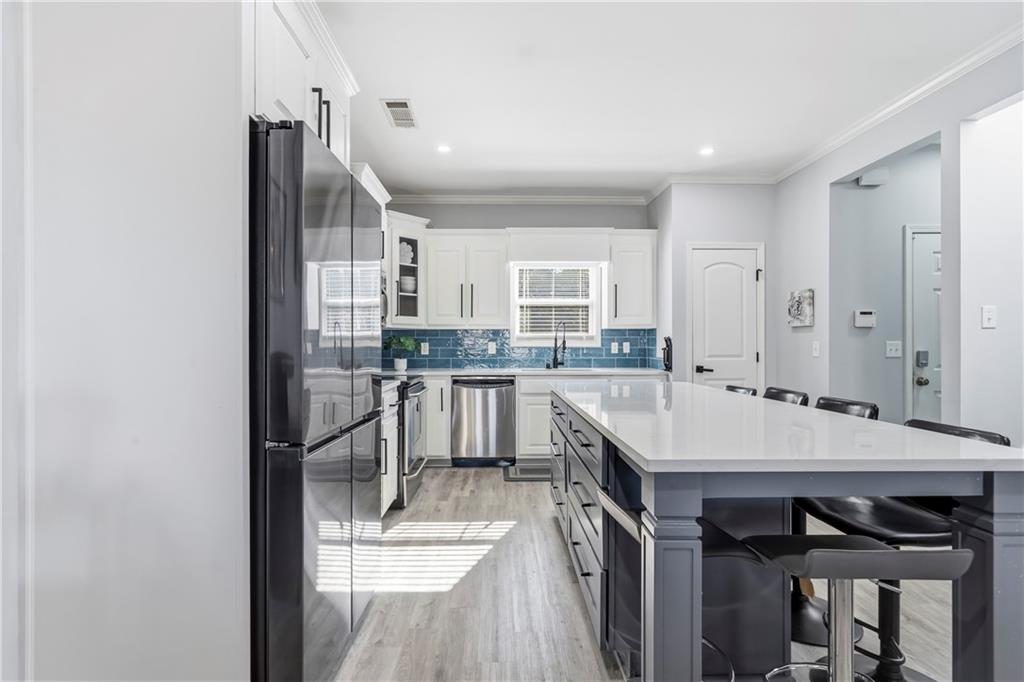 549 Old Phoenix Road Northeast, Unit 104 Eatonton, GA 31024 - Photo 8 of 49 a kitchen with a table and chairs