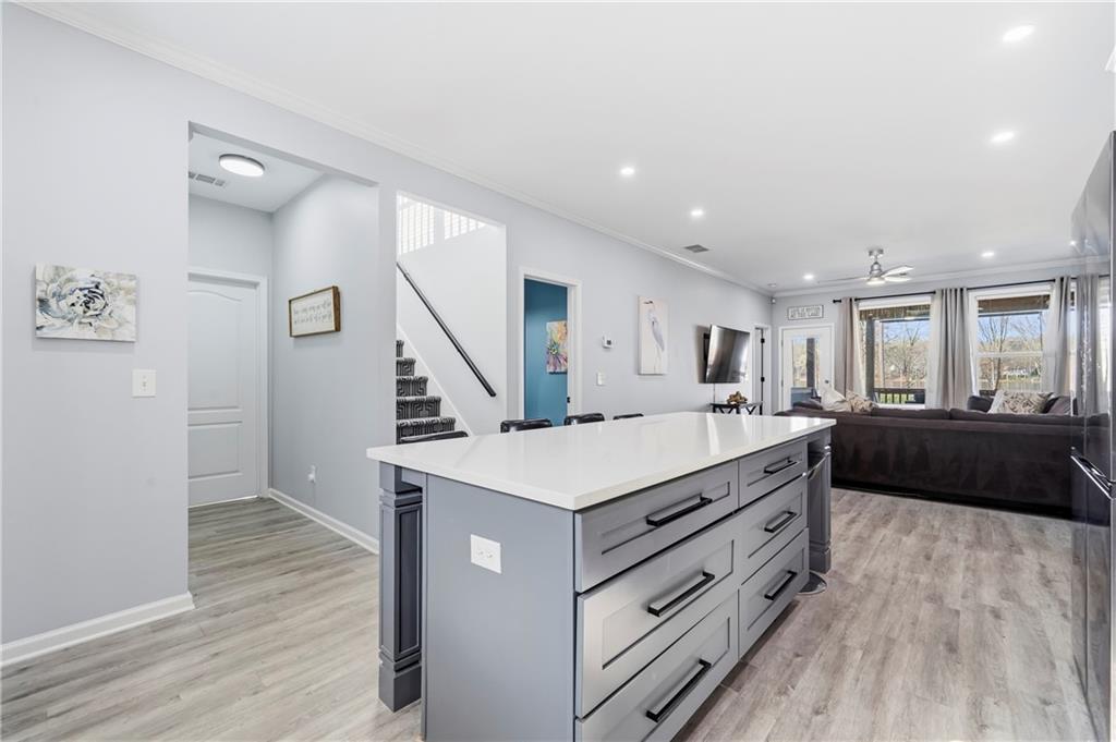 549 Old Phoenix Road Northeast, Unit 104 Eatonton, GA 31024 - Photo 9 of 49 a large room with a large bed and wooden floor