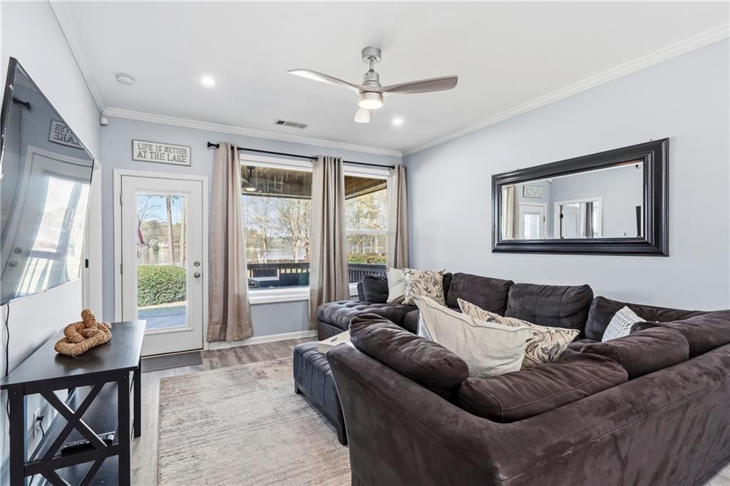549 Old Phoenix Road Northeast, Unit 104 Eatonton, GA 31024 - Photo 10 of 49 a living room with furniture and large windows