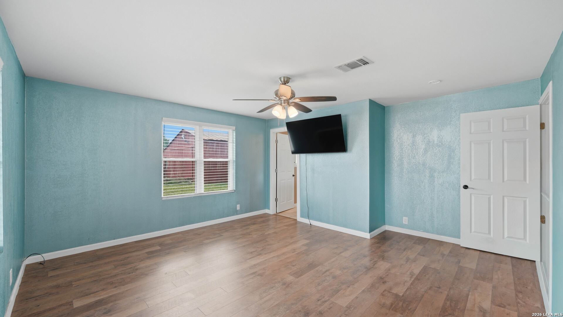 106 County Road 6611 Devine, TX 78016 - Photo 13 of 29 a view of empty room with wooden floor and fan
