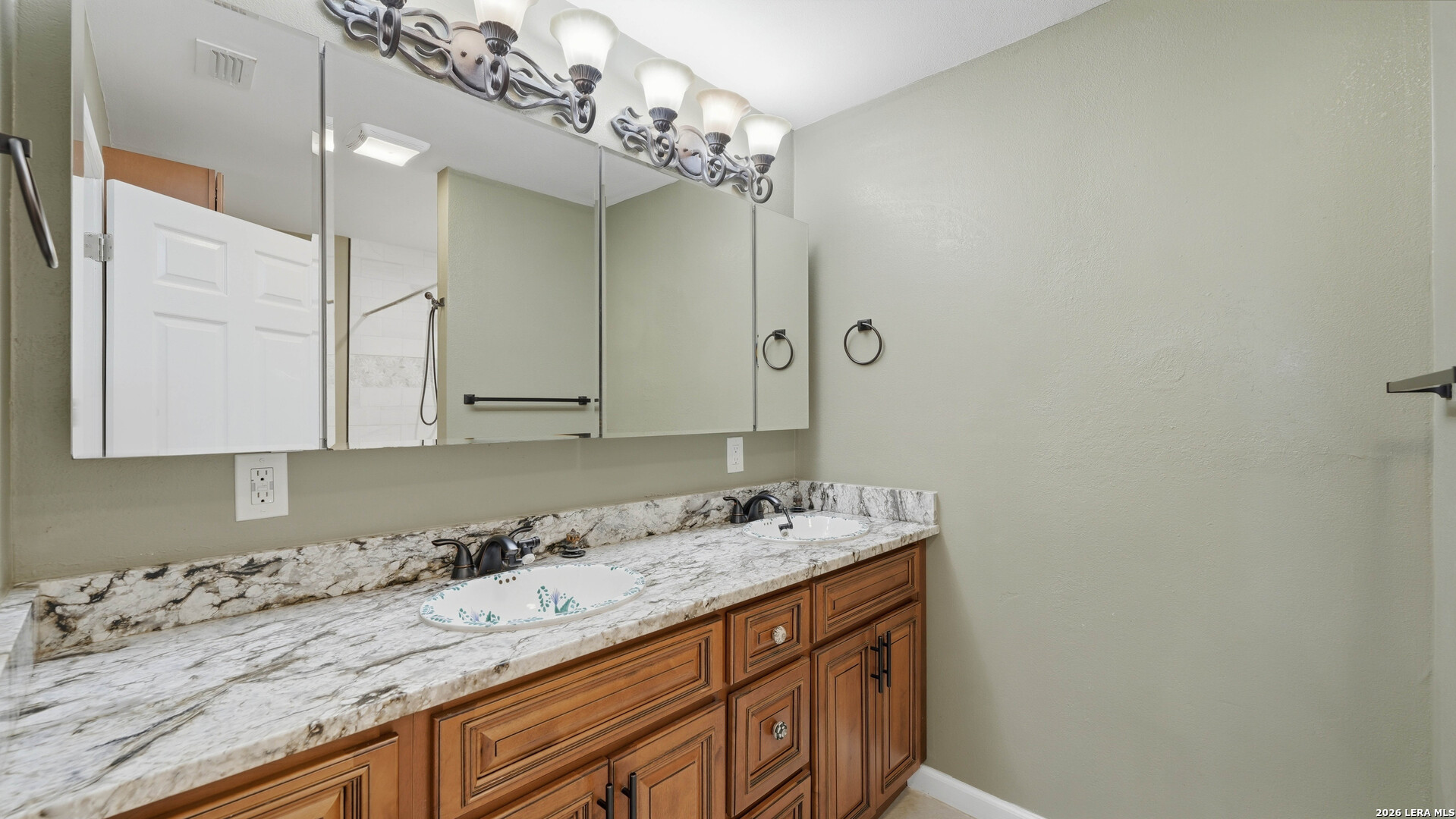 106 County Road 6611 Devine, TX 78016 - Photo 14 of 29 a bathroom with a sink and a mirror