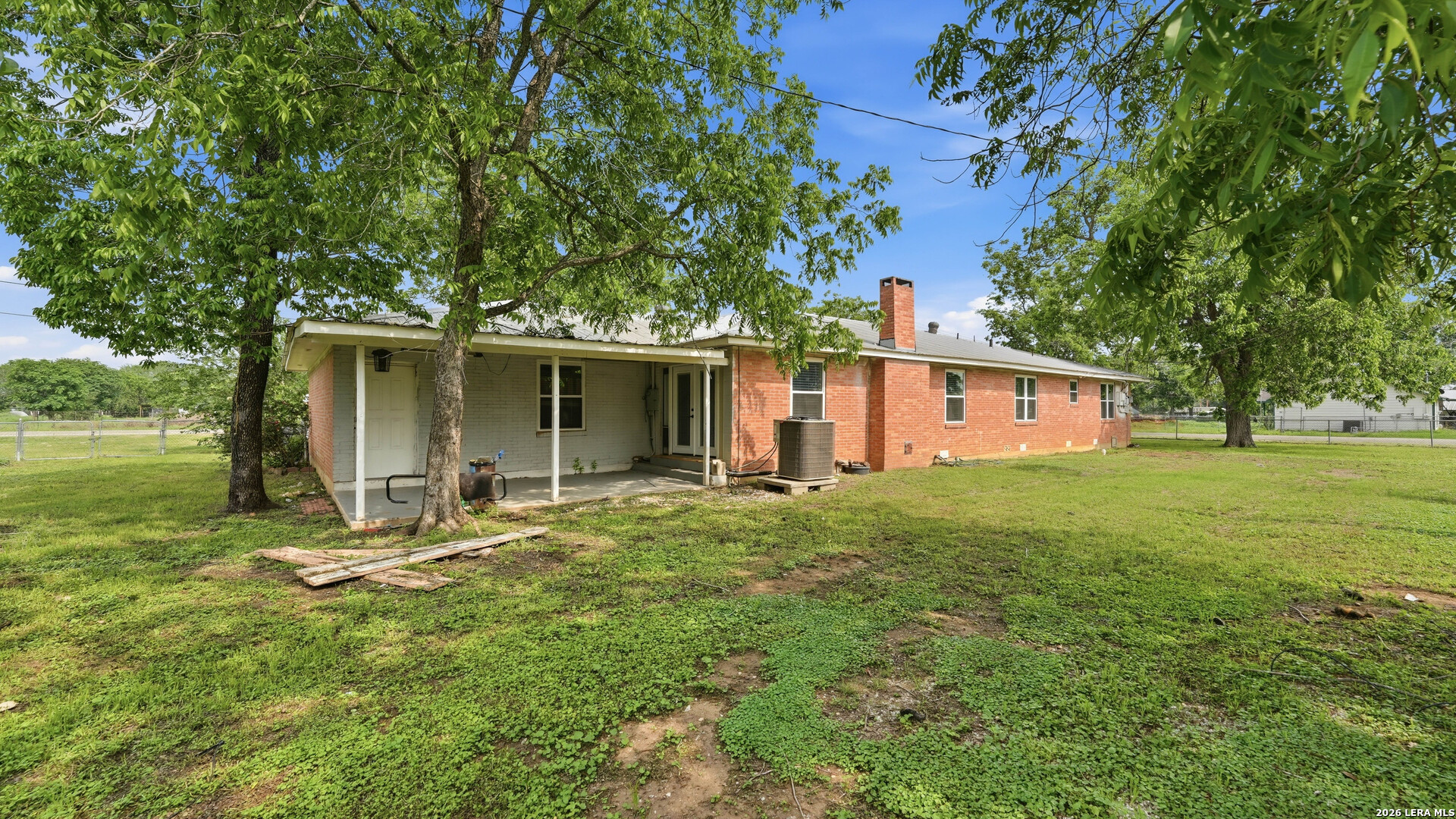 106 County Road 6611 Devine, TX 78016 - Photo 26 of 29 a front view of house with yard and green space
