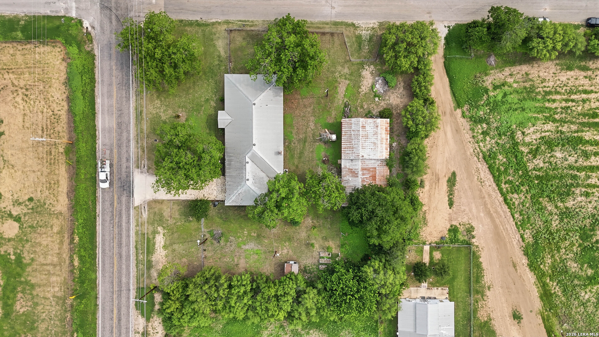 106 County Road 6611 Devine, TX 78016 - Photo 28 of 29 an aerial view of residential house with outdoor space and trees all around